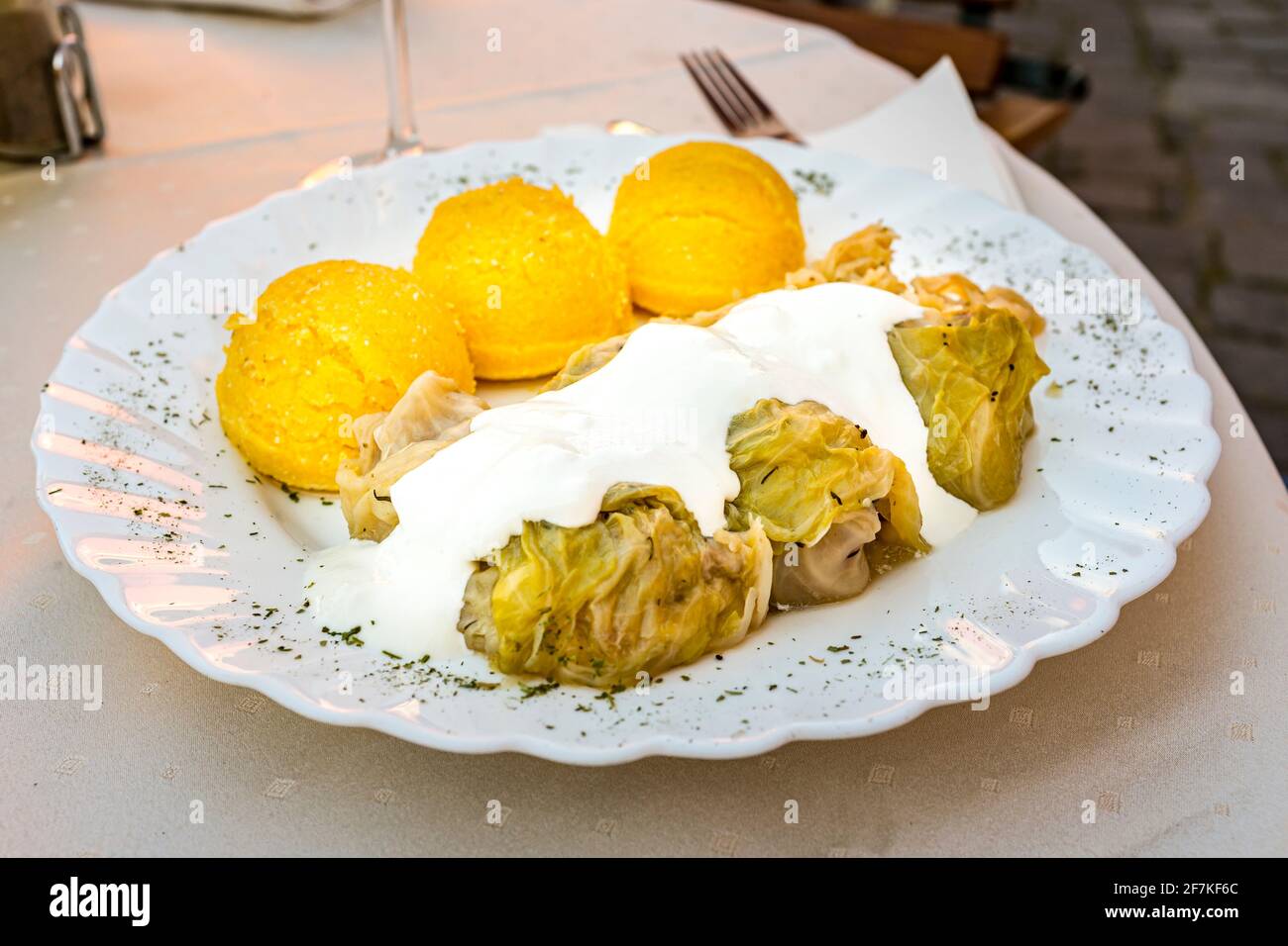 Sarmale (cabbage rolls) with Mamaliga (polenta) is a popular dish in Romania Stock Photo