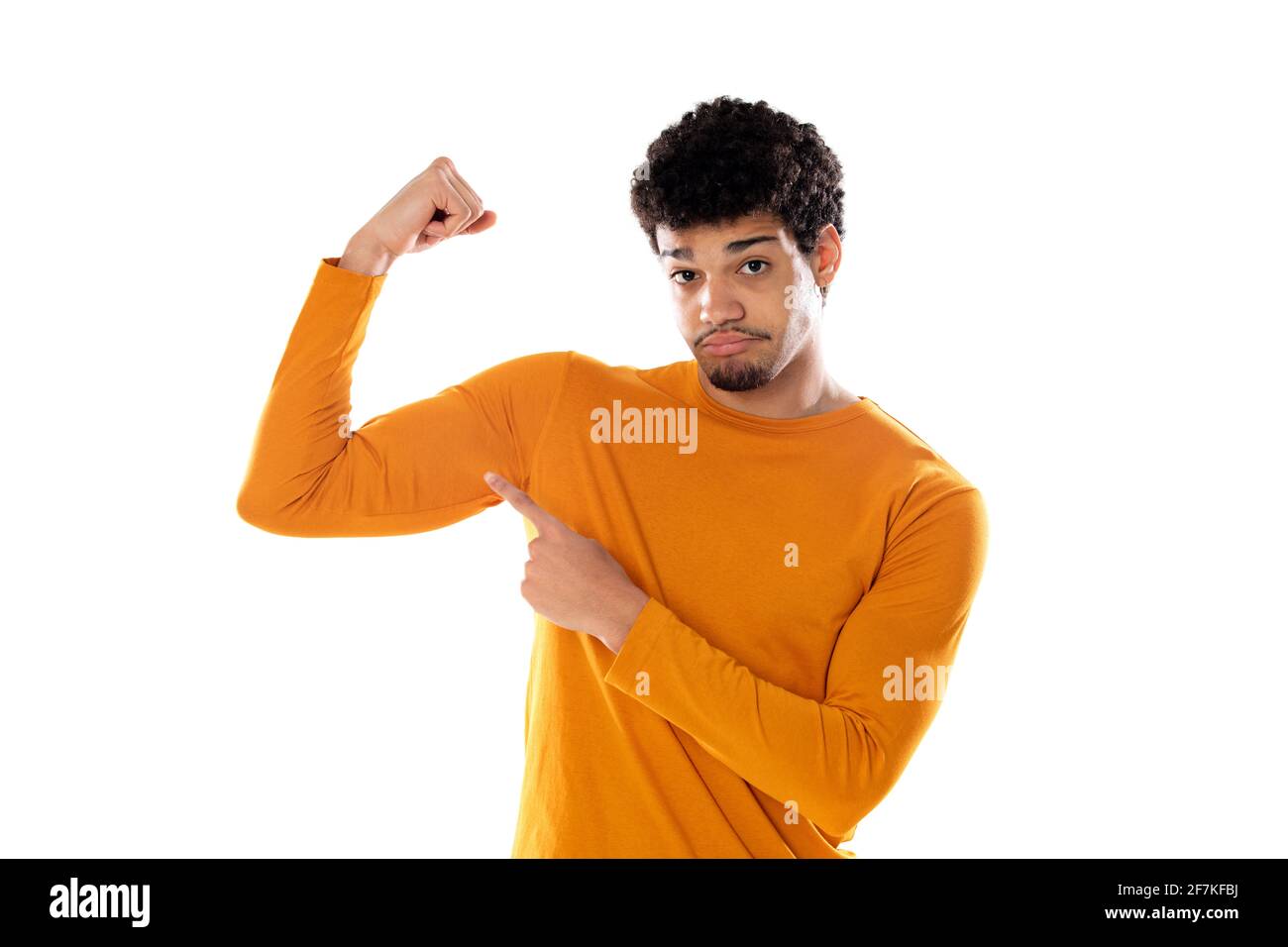 Young african american black man feeling happy, satisfied and powerful, flexing fit and muscular biceps, looking strong after the gym against isolated Stock Photo