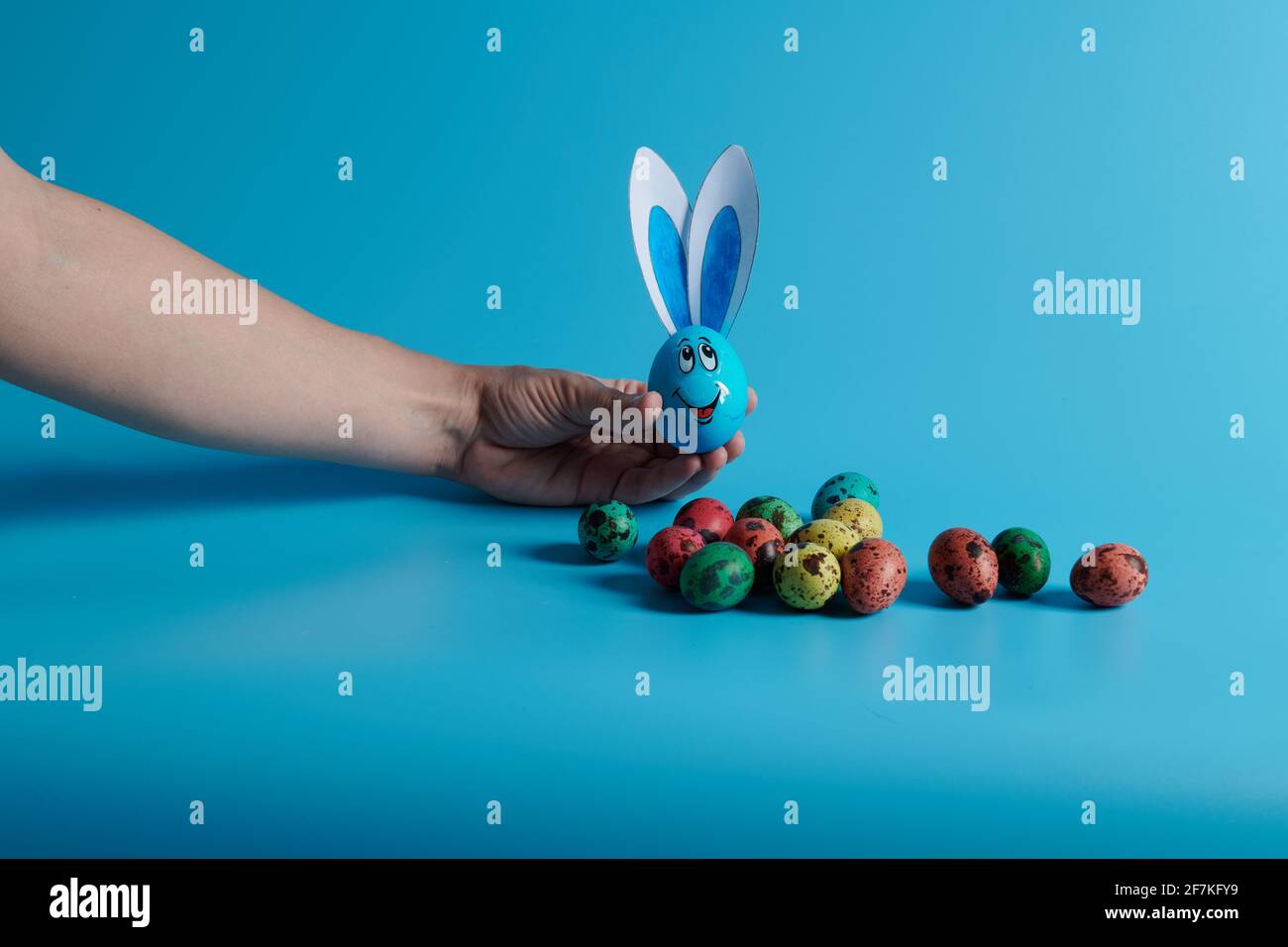 Easter eggs and egg with ears on a blue background Stock Photo