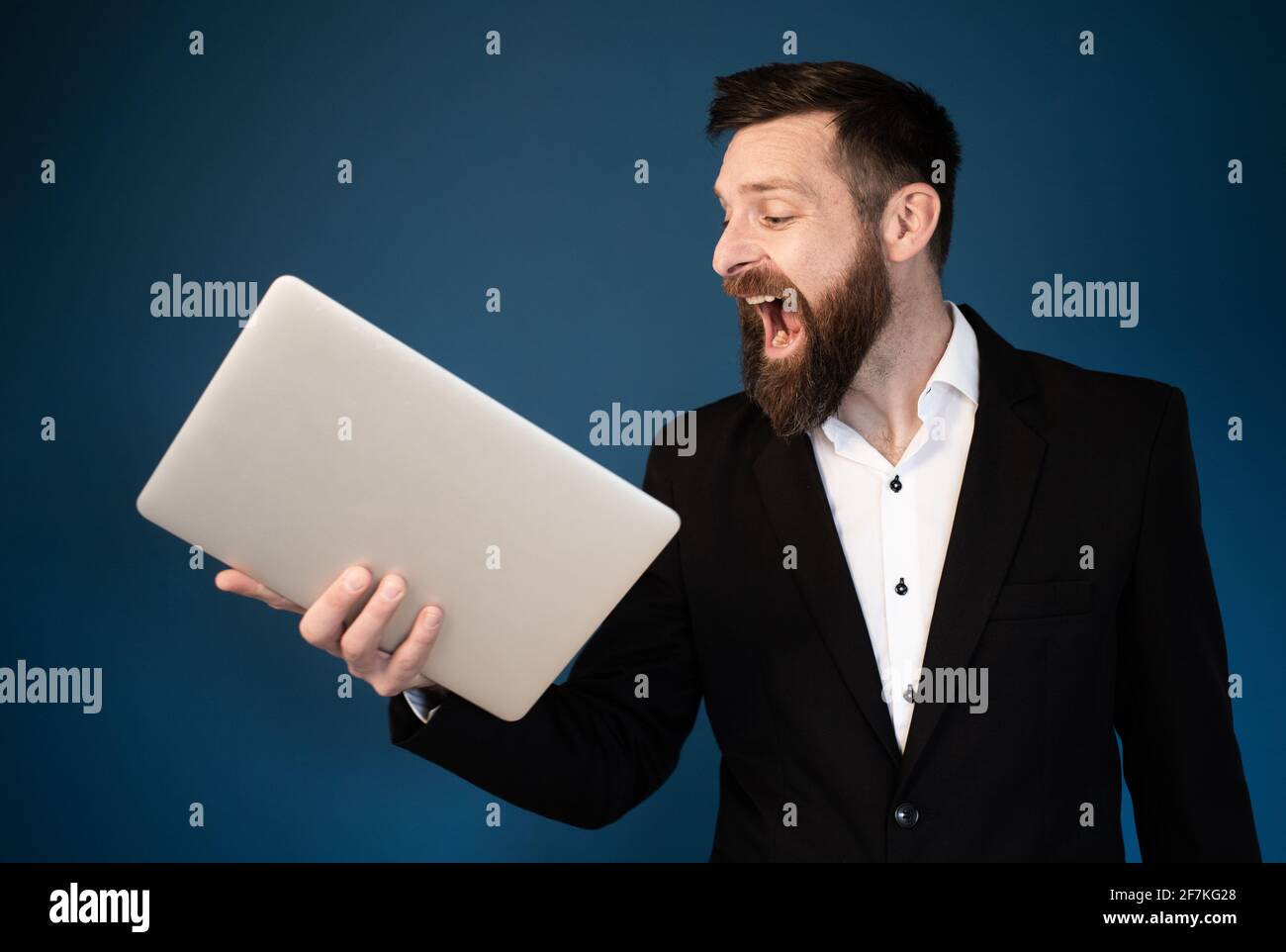 angry businessman shouting at laptop Stock Photo