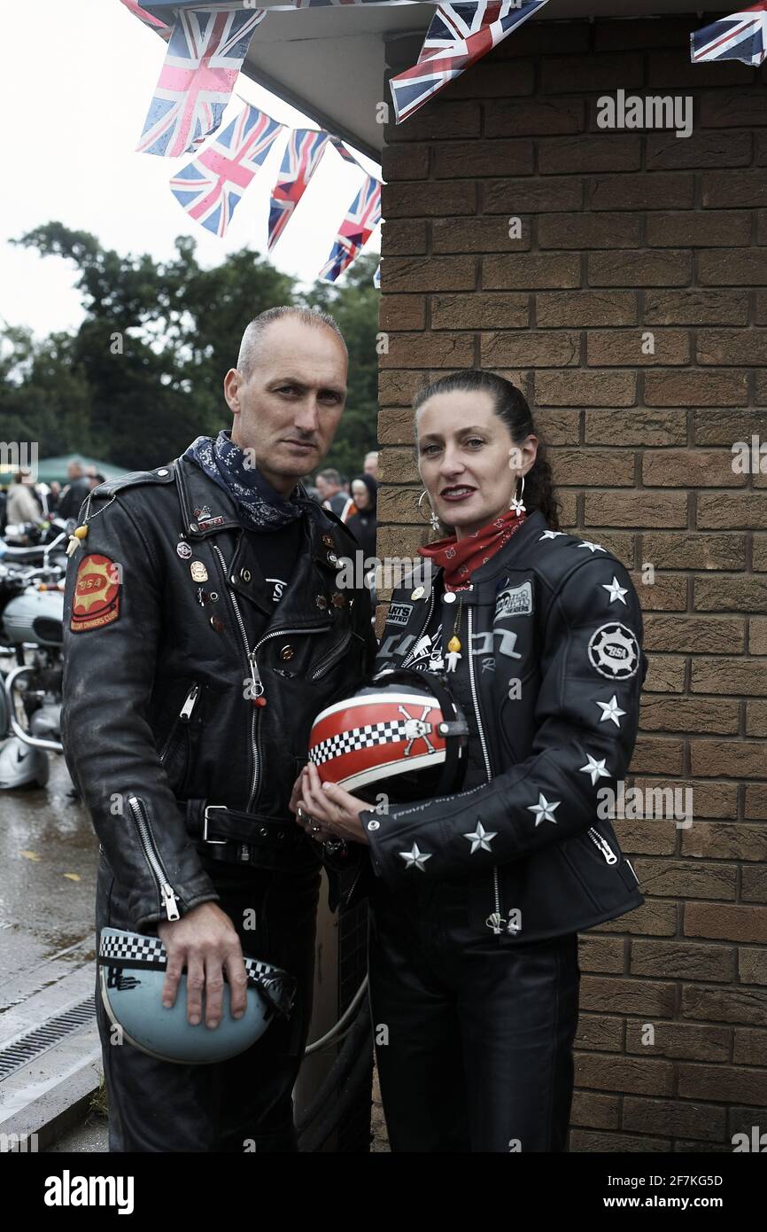 Rocker couple wearing leather jackets patches and badges at Ton up Day, Jacks Hill Cafe, Northamptonshire, England. Stock Photo