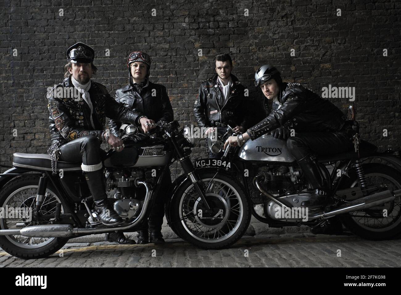 Rocker gang posing with British classic Triumph,Triton motorcycles . Rockers on classic cafe racer motorcycles in London , UK. Stock Photo