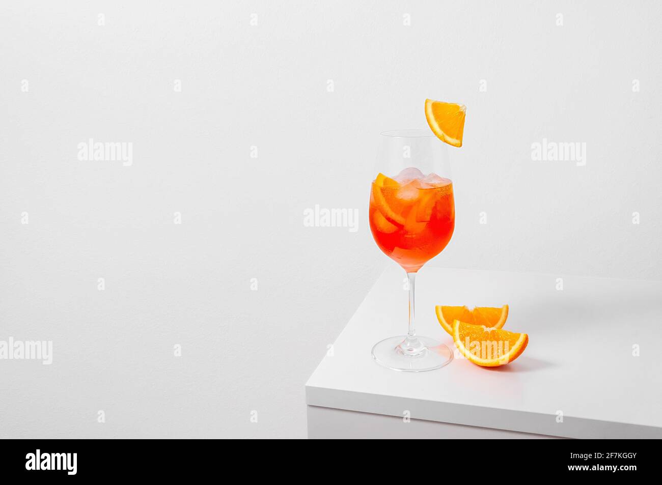 Aperol Spritz Cocktail in wine glass with ice and orange slice on white ...