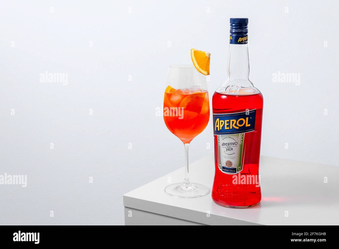 Lugansk, Ukraine - March 29, 2021: Aperol Spritz Cocktail. Aperol in bottle  and wine glass with ice on white background. Long fizzy drink. Minimal cre  Stock Photo - Alamy