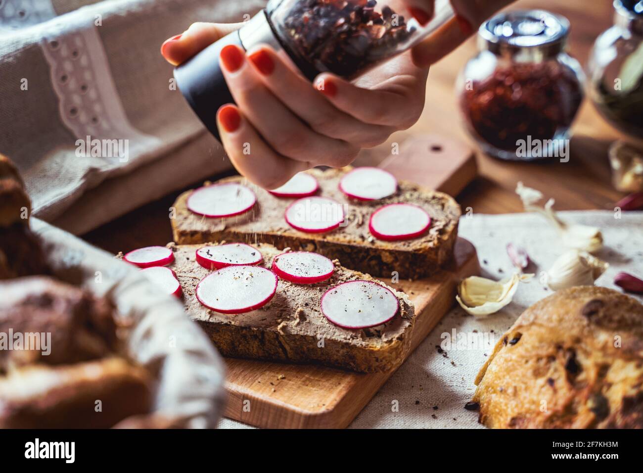 Sliced and plated Sourdough bread. Vegan vegetables on rustic crusty fresh country bread. Stock Photo