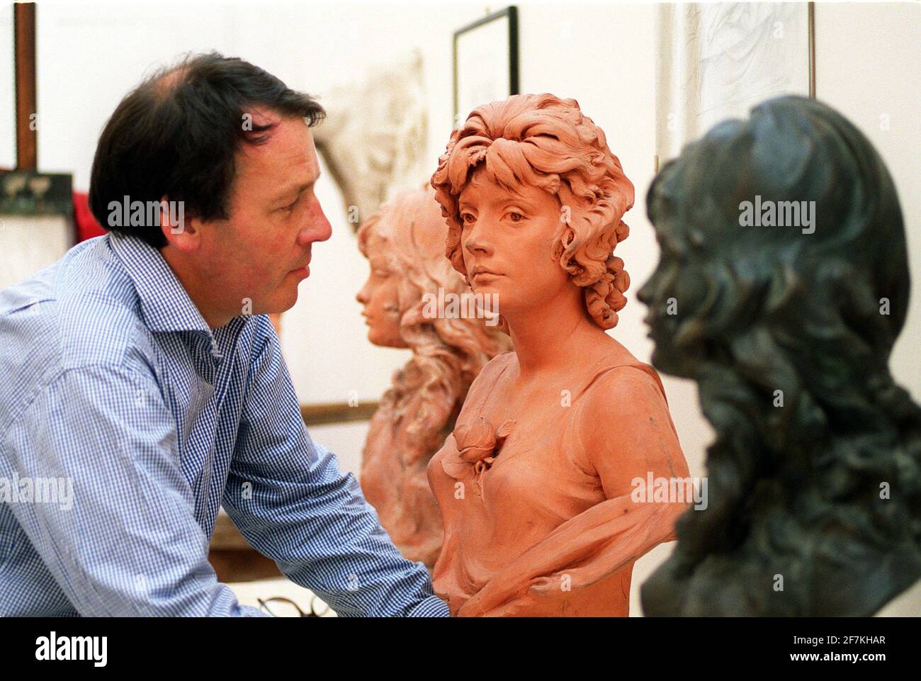 Francis Machin admires sculptures  of his father Arnold - creator of the  Queen's postage stamp image - which form part of an exhibition of the artist's work  at the Royal Academy London.photo Stock Photo