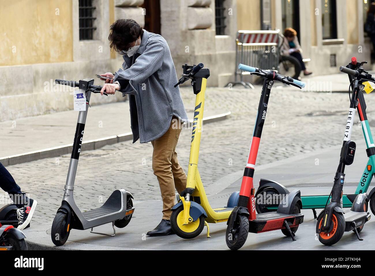 Italy, Rome, March 11, 2021 People riding an electric scooter across