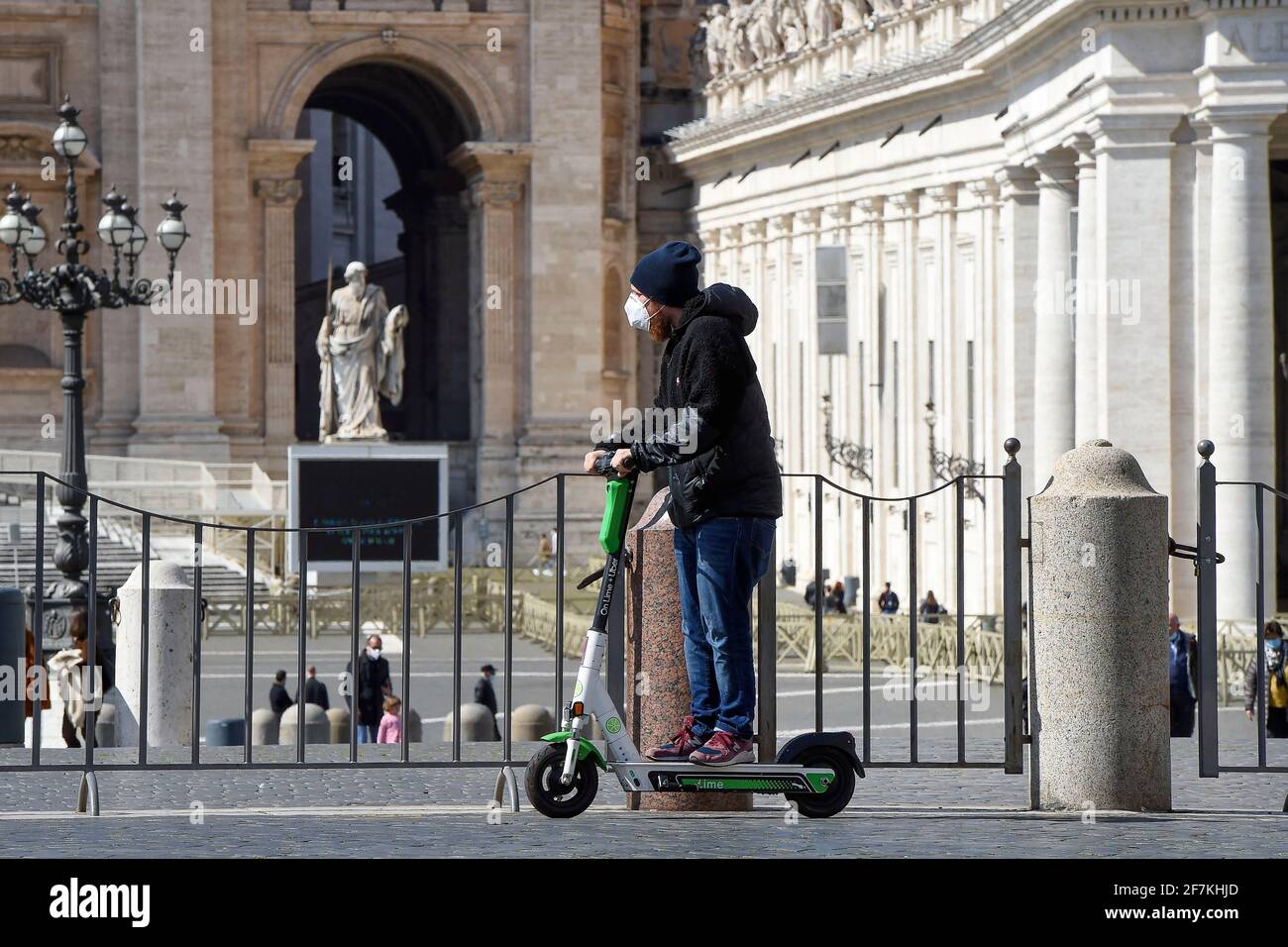 Italy, Rome, March 13, 2021 : People riding an electric scooter in Saint Peter Square   Photo © Fabio Mazzarella/Sintesi/Alamy Stock Photo Stock Photo