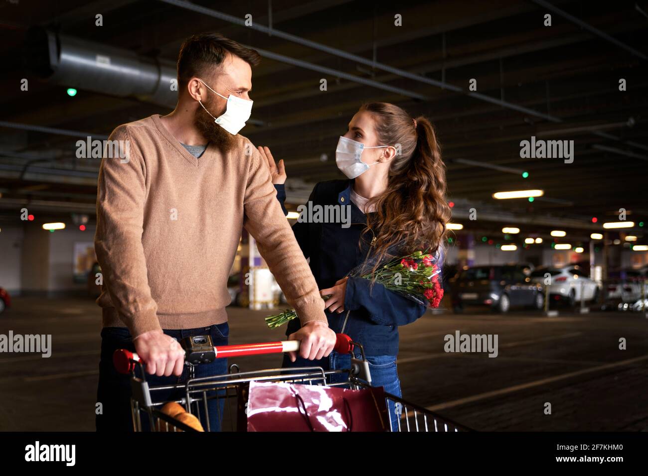Couple walking with shopping cart after shopping Stock Photo