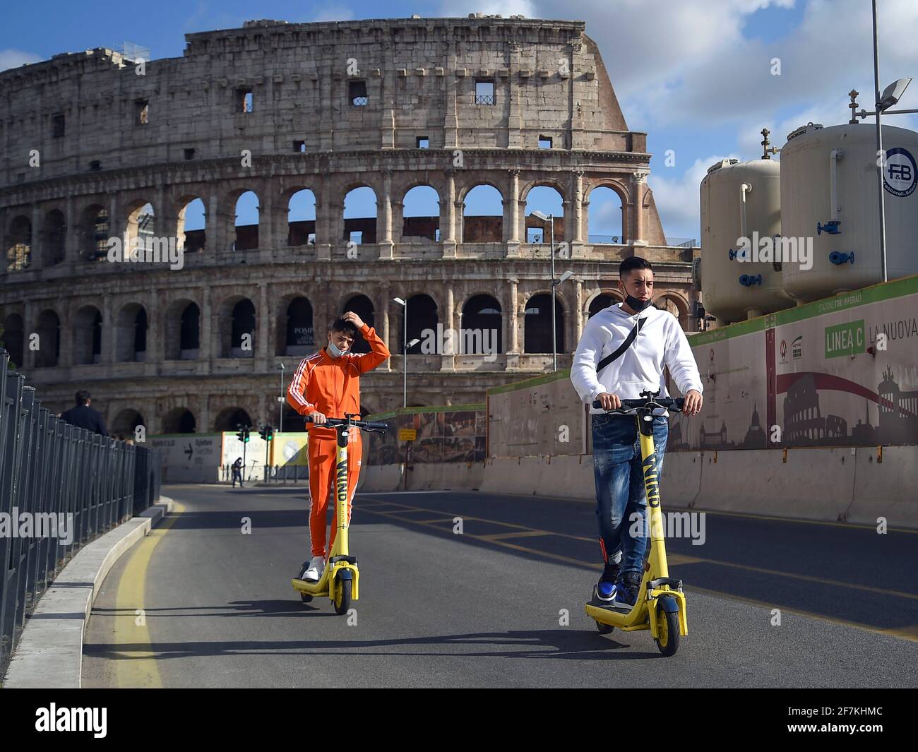 Italy, Rome, March 13, 2021 : People riding an electric scooter near the Coliseum area   Photo © Fabio Mazzarella/Sintesi/Alamy Stock Photo Stock Photo