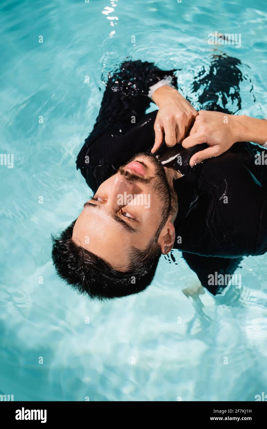 Summer business dreams. Millennial business man in suit floating with  cocktail and laptop in swimming pool. Summer vacation. Funny crazy  businessman Stock Photo - Alamy
