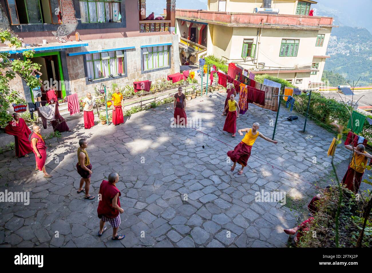 Young monks play jianzi at the Rumtek monastery, largest monastery in Sikkim, India. Jianzi is a traditional Chinese national sport in which players a Stock Photo