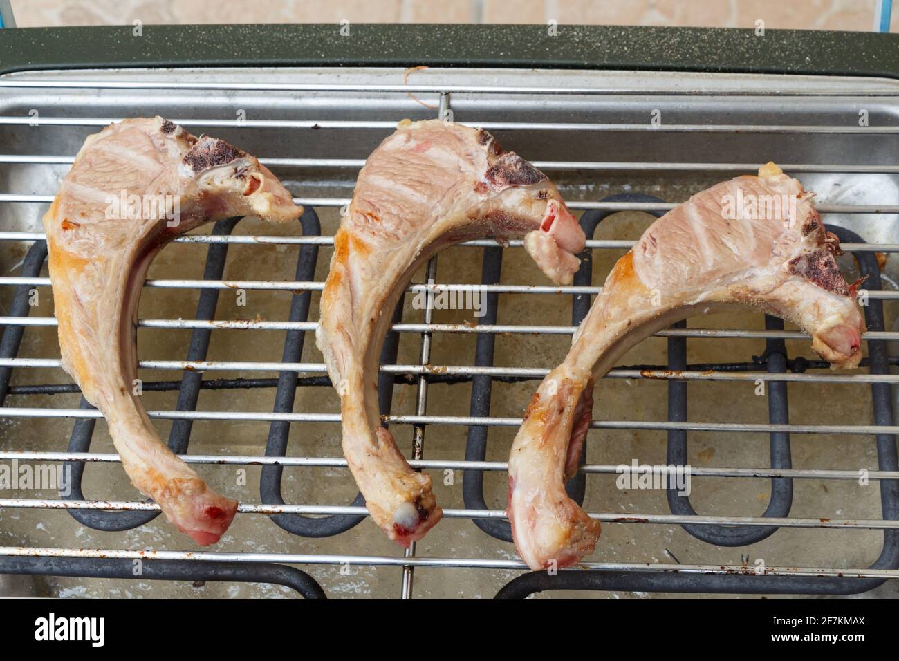 Lamb chops on the grid of an electric barbecue Stock Photo