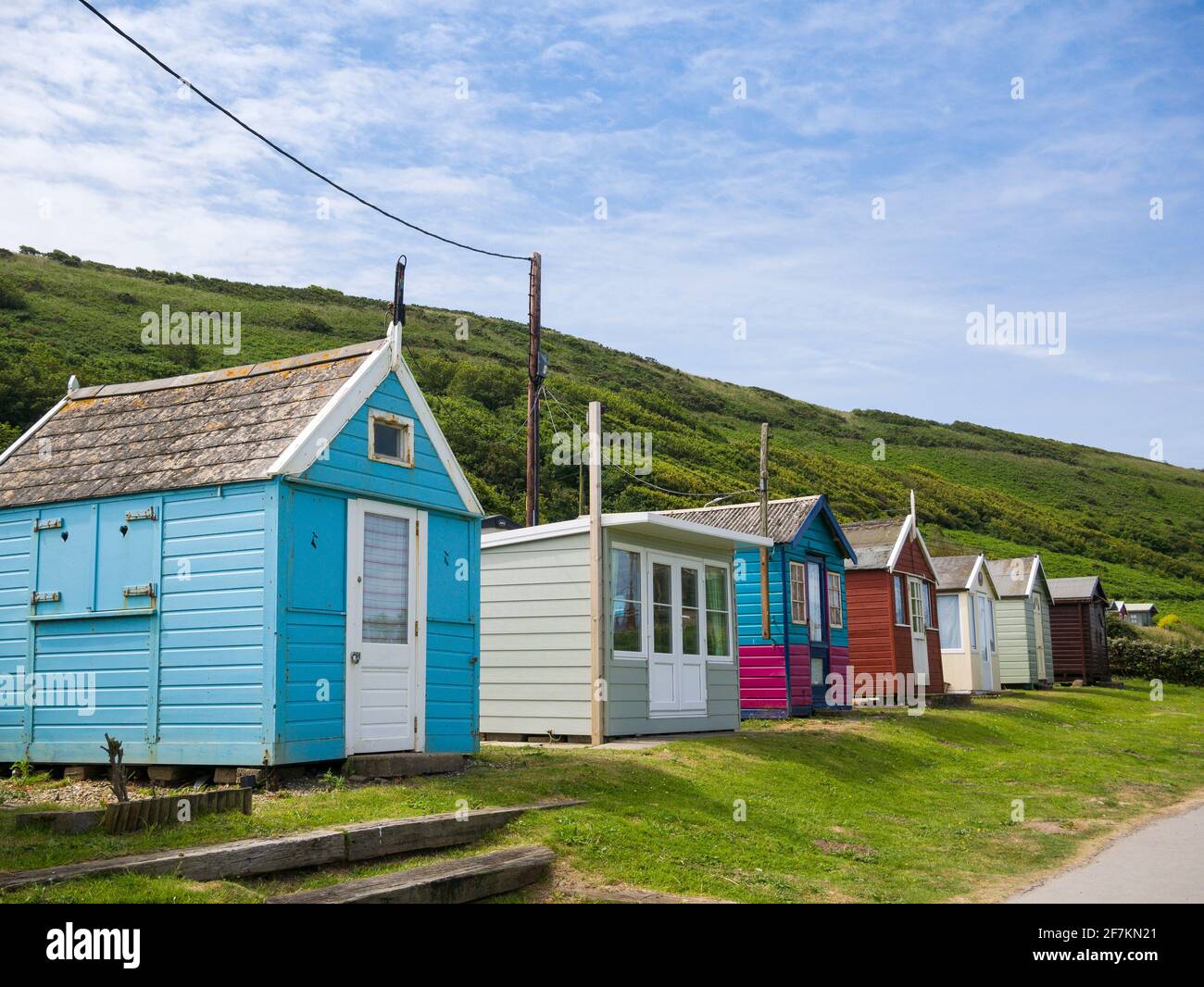 Beach Huts at the seaside village of Westward Ho! below Kipling Tors, North Devon, England. Stock Photo