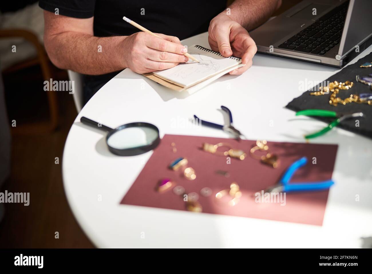 Craftsman Notebook Craftsman sketching a new pendant on a blank notebook page Stock Photo ...