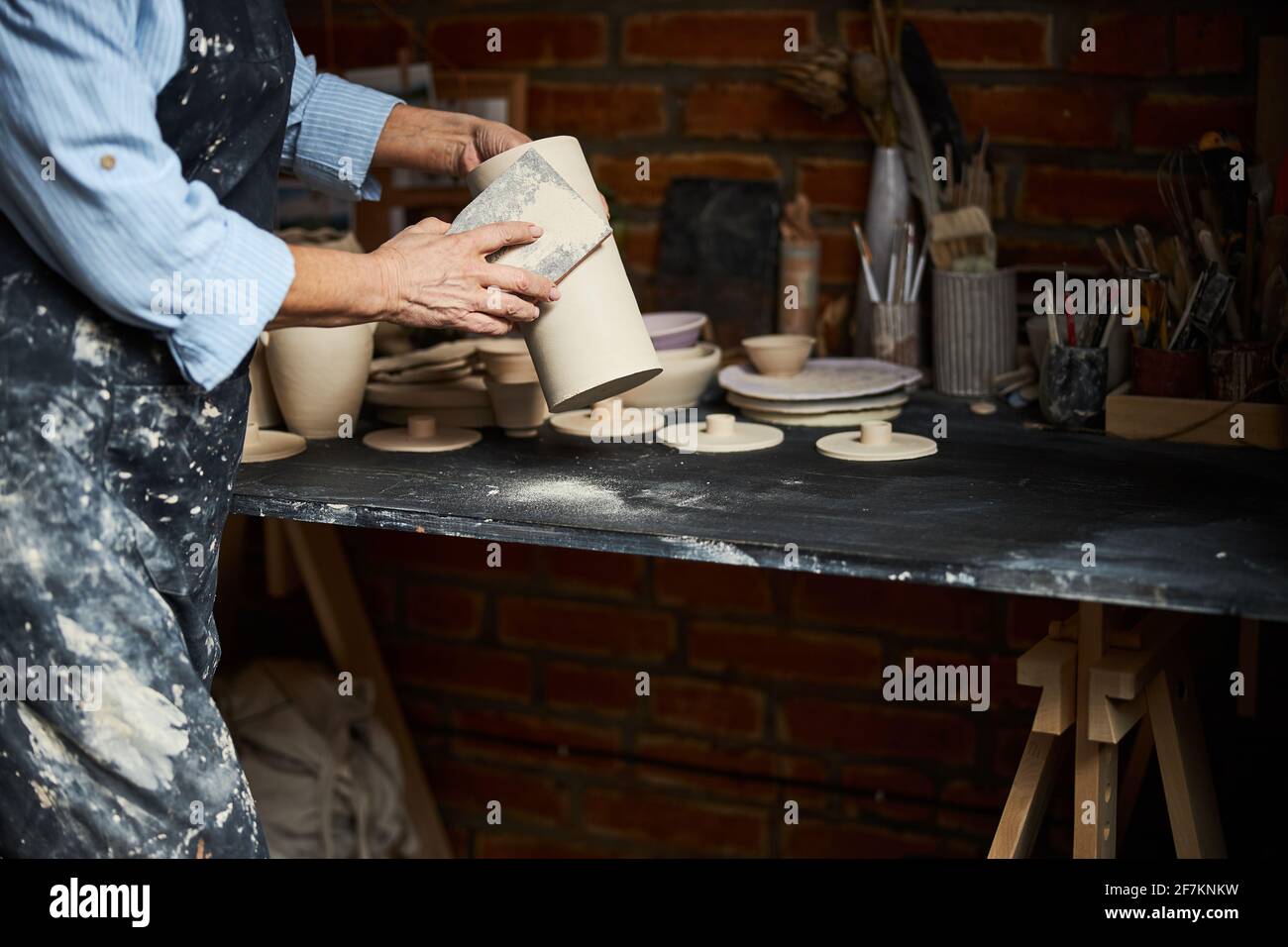Female ceramic artist hands polishing pottery in workshop Stock Photo ...