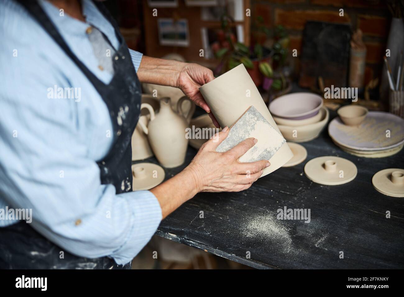 Female ceramic artist working in pottery studio Stock Photo - Alamy