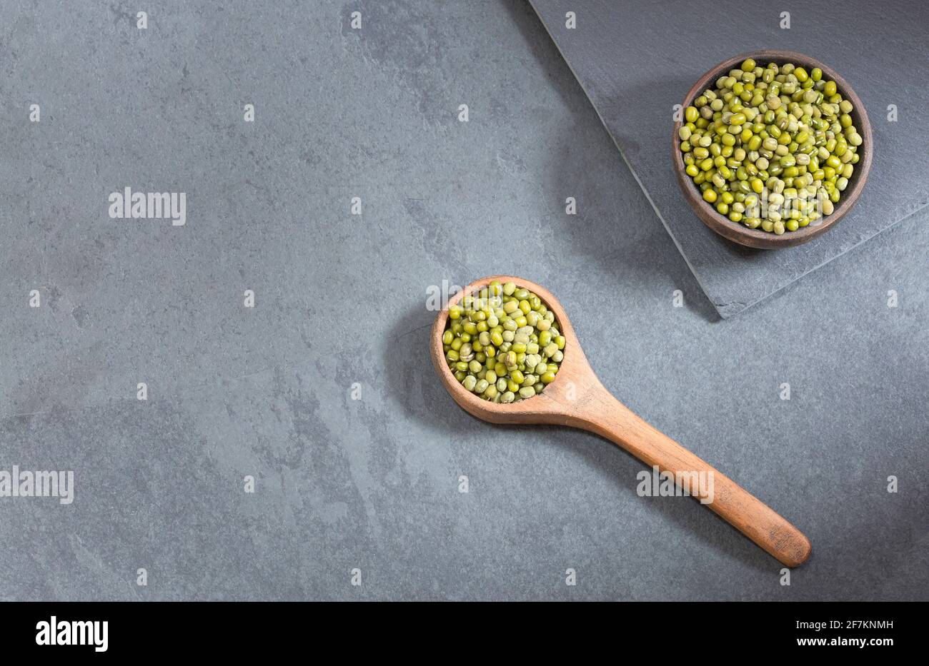 Mung beans in the wooden spoon. Top view - Vigna radiata Stock Photo