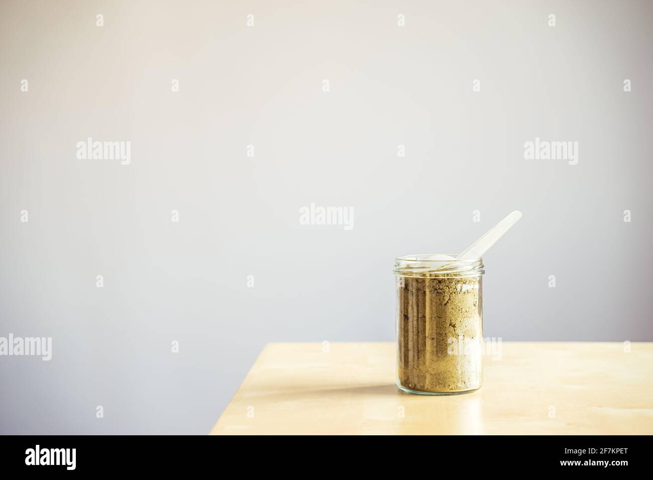 Jar of hemp protein powder. Space for text Stock Photo