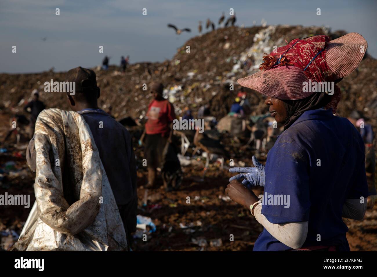 KAMPALA, UGANDA: Around 800 workers are employed at the landfill site. IMAGES showing exhausted Ugandan workers sifting through mountainous tons of du Stock Photo