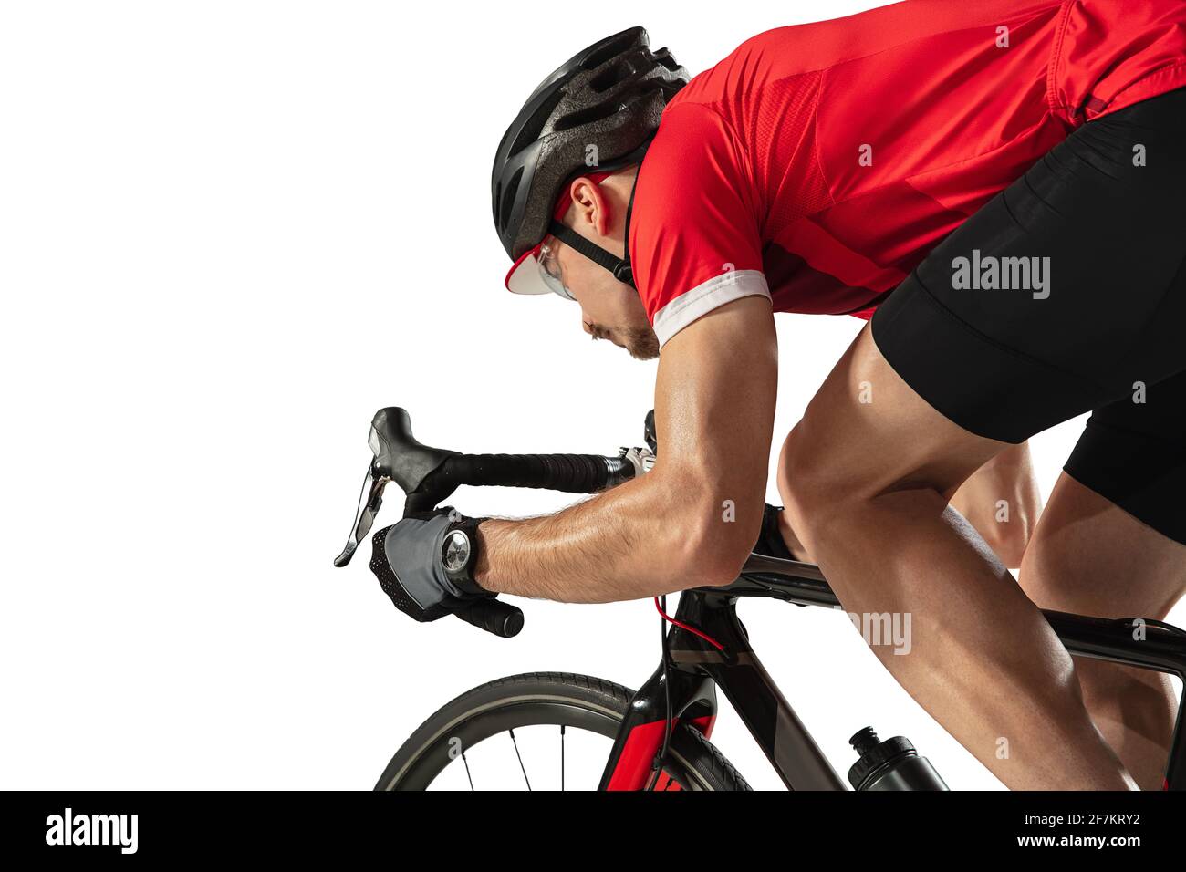 Young professional male bike rider on road bike isolated over white ...