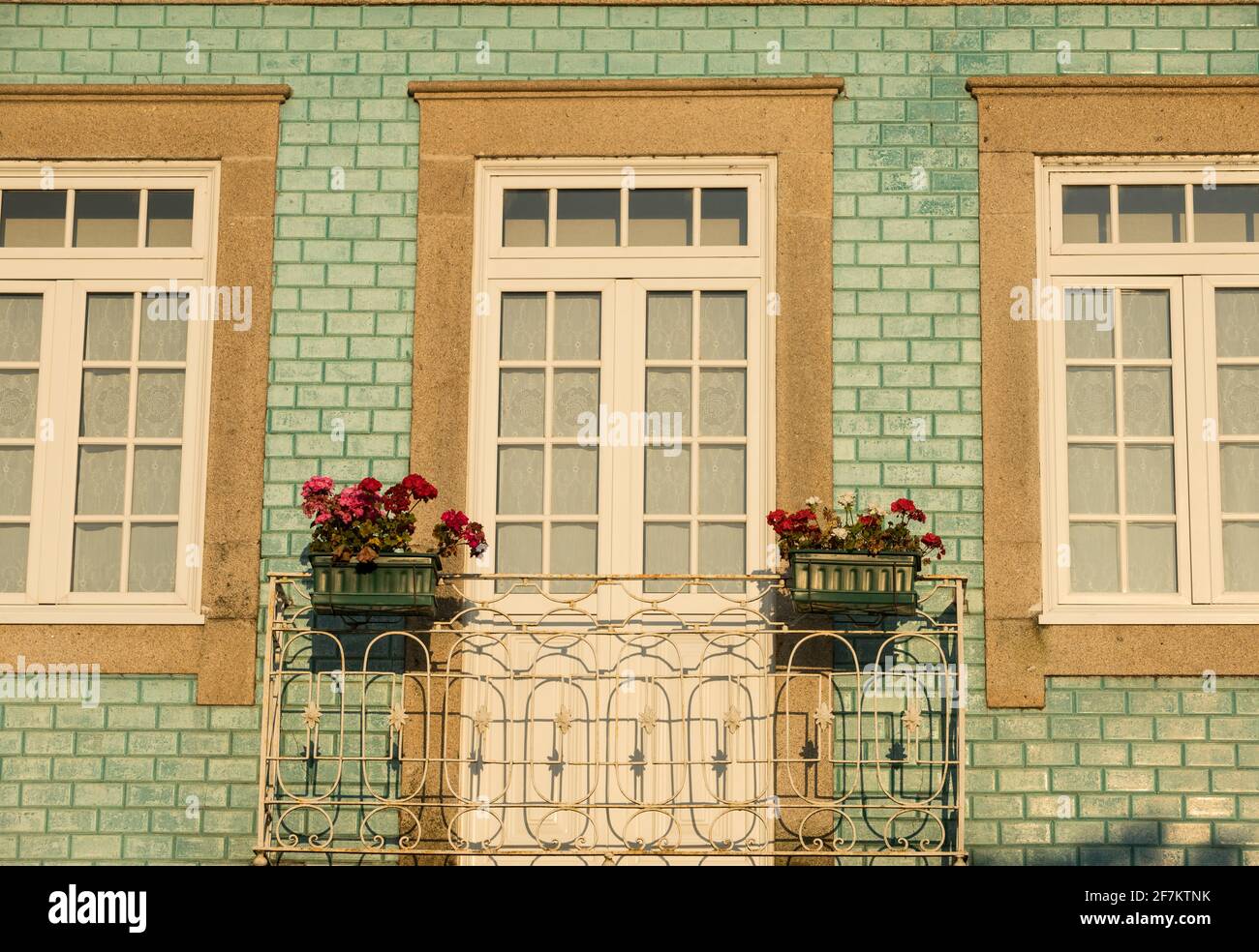 Typical old portuguese house with light green tiles. Front house facade. Stock Photo
