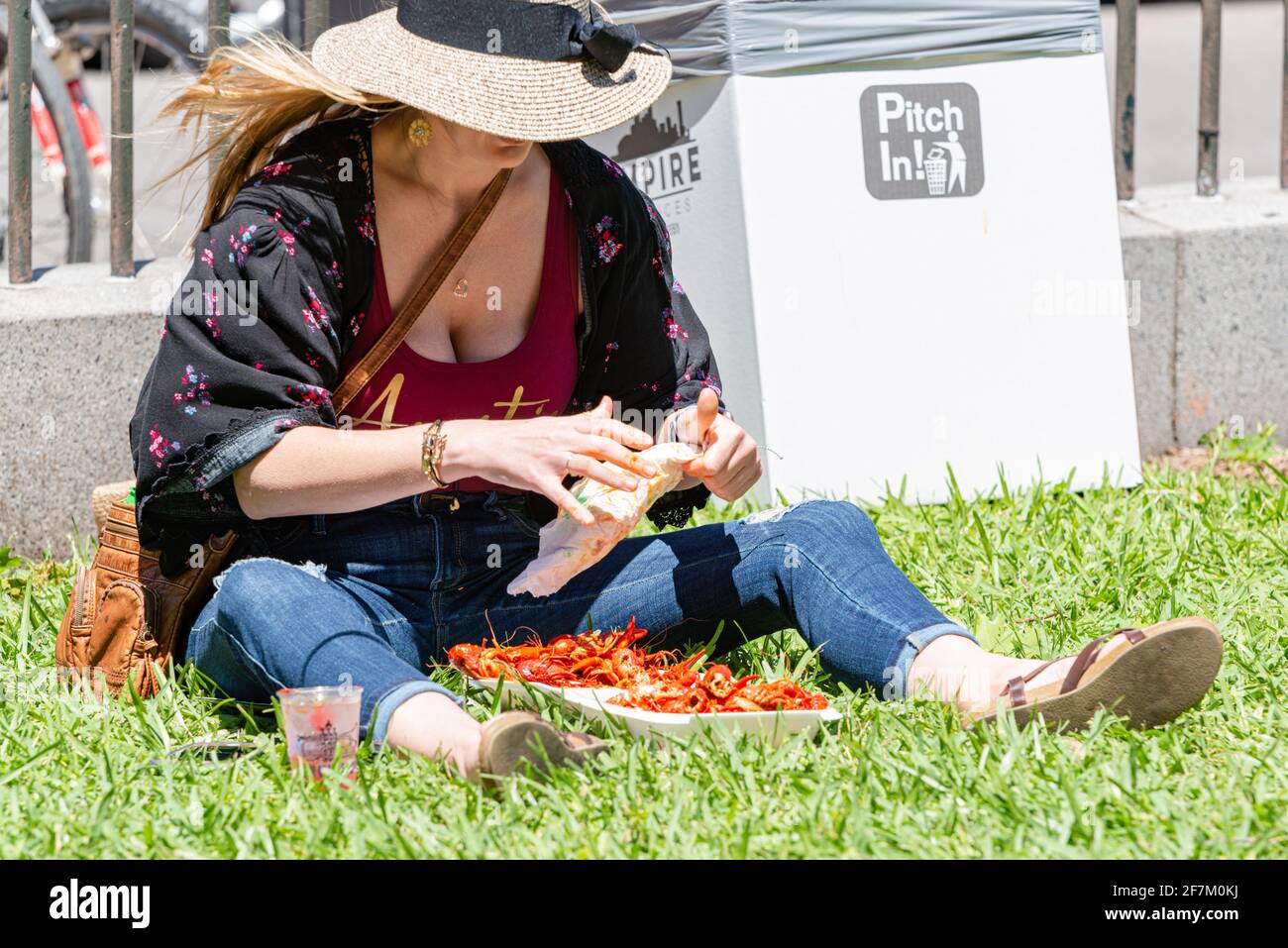 NEW ORLEANS, LA, USA - APRIL 14, 2019: Woman Eating Crawfish at French Quarter Festival (Free) in New Orleans Stock Photo