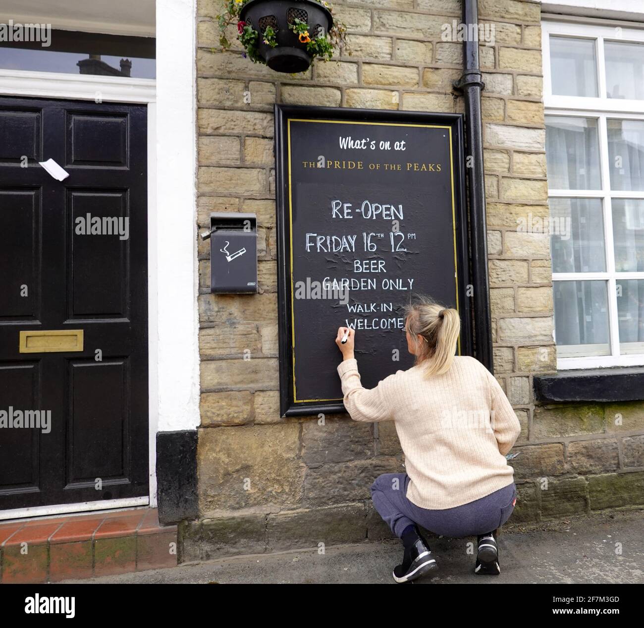 A woman informs the public that The Pride of the Peaks pub in New Mills