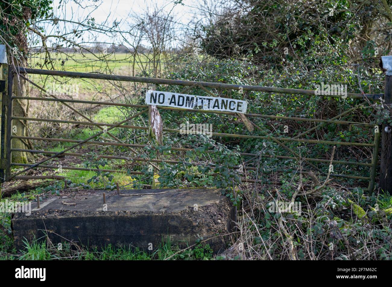 A no admittance sign on an old gate blocking a track on a farm in the Cambridgeshire Fens UK Stock Photo