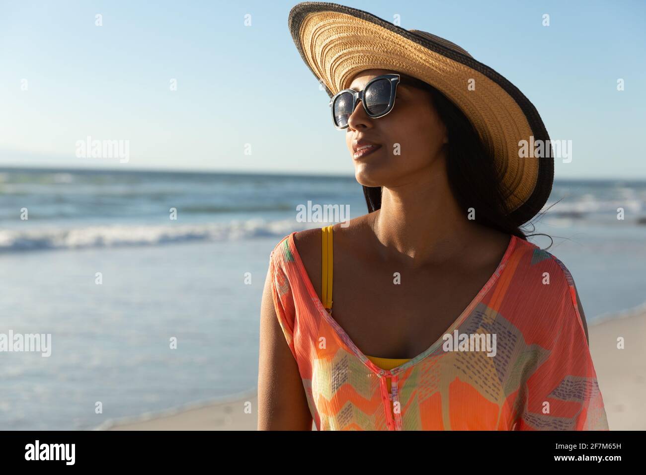 Portrait of mixed race woman on beach holiday Stock Photo