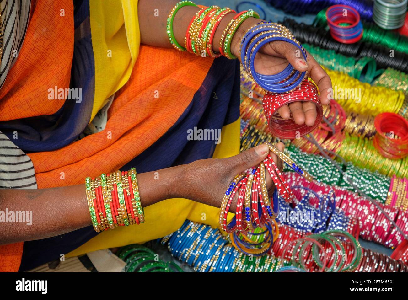 Kunduli, India - February 2021: Adivasi woman from the Kondh tribe selling bracelets in the Kunduli market on February 19, 2021 in Odisha, India. Stock Photo