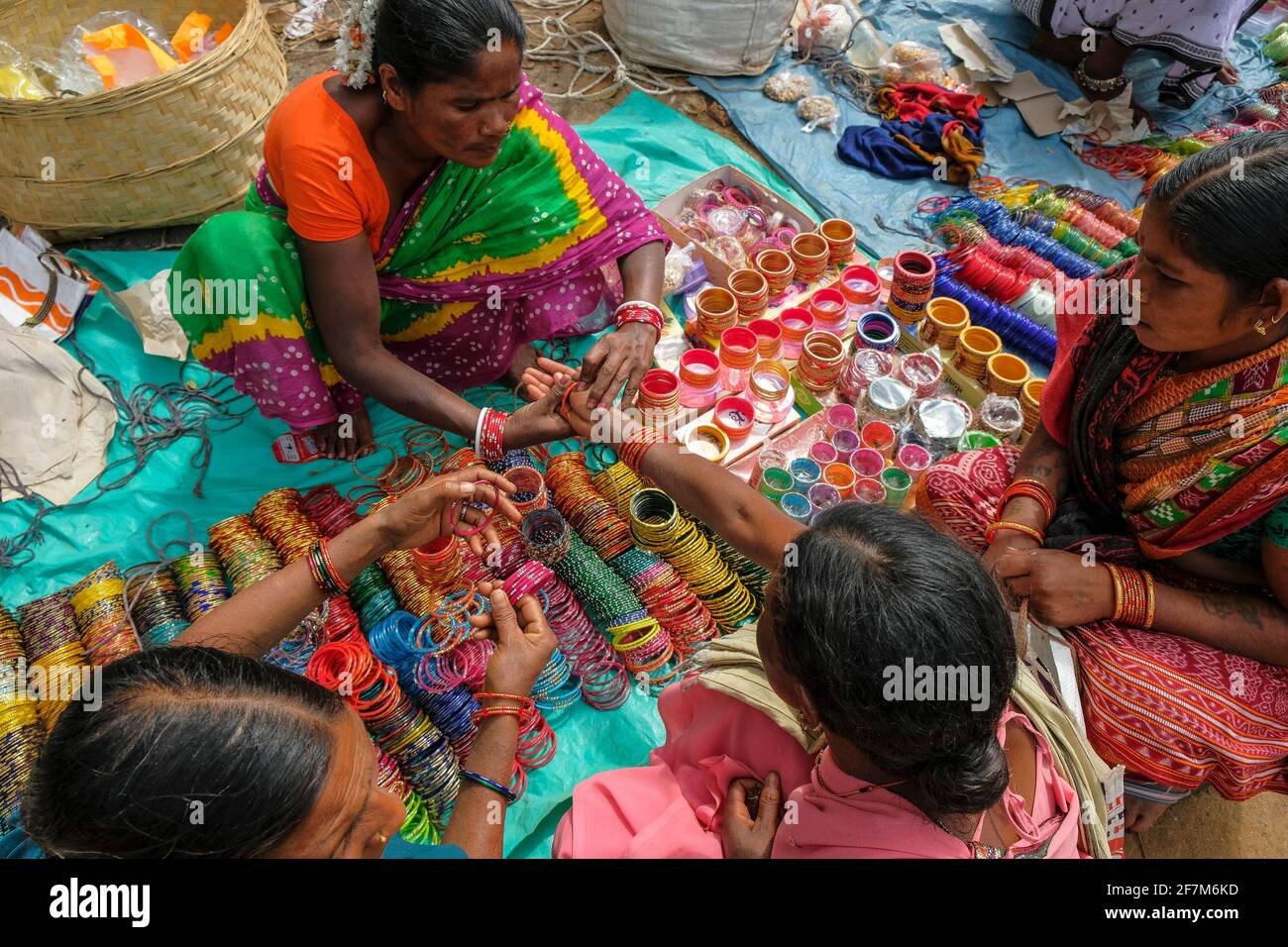 Kunduli, India - February 2021: Adivasi women from the Kondh tribe buying bracelets in the Kunduli market on February 19, 2021 in Odisha, India. Stock Photo