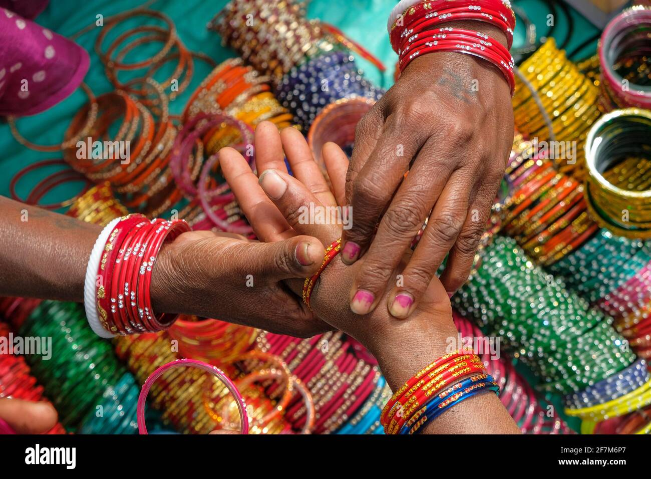 Kunduli, India - February 2021: Adivasi woman from the Kondh tribe buying bracelets in the Kunduli market on February 19, 2021 in Odisha, India. Stock Photo