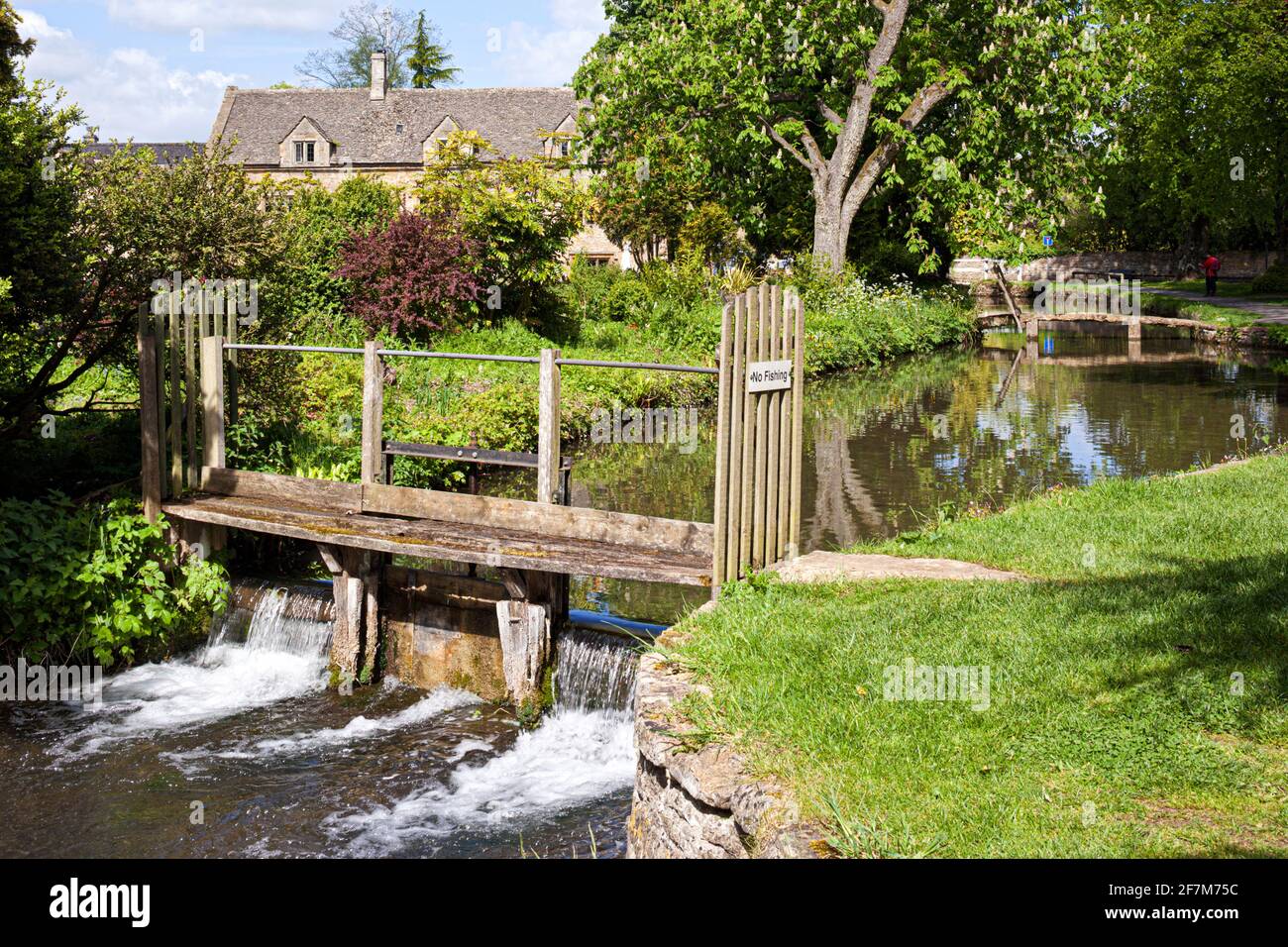 The River Eye flowing through the Cotswold village of Lower Slaughter, Gloucestershire UK Stock Photo