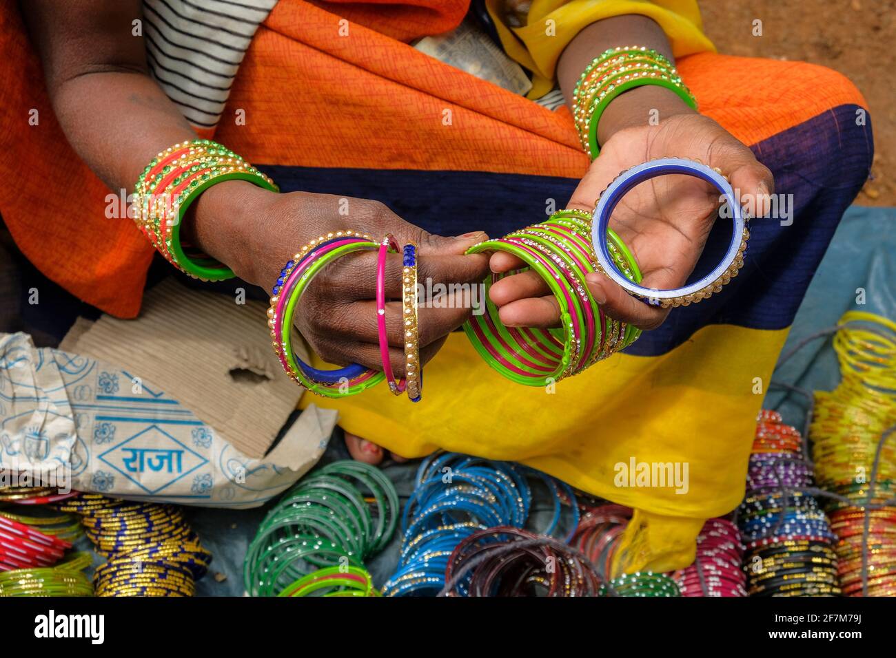 Kunduli, India - February 2021: Adivasi woman from the Kondh tribe selling bracelets in the Kunduli market on February 19, 2021 in Odisha, India. Stock Photo