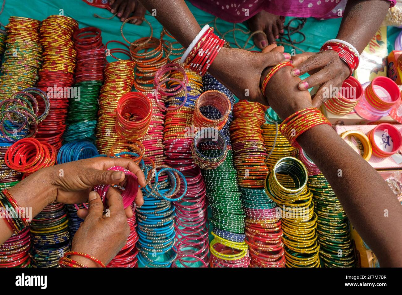 Kunduli, India - February 2021: Adivasi women from the Kondh tribe buying bracelets in the Kunduli market on February 19, 2021 in Odisha, India. Stock Photo