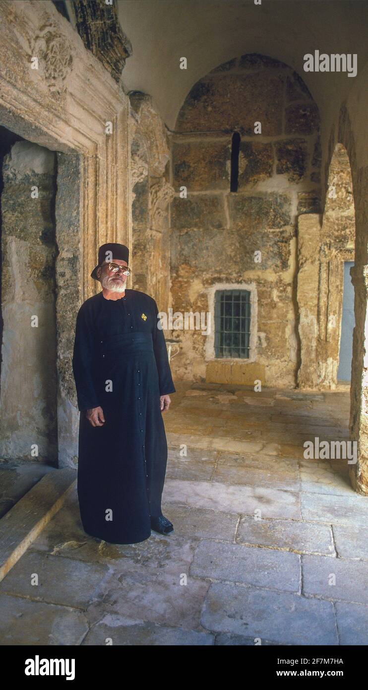 Orthodox Christian priest in church cloister Mardin Turkey Stock Photo