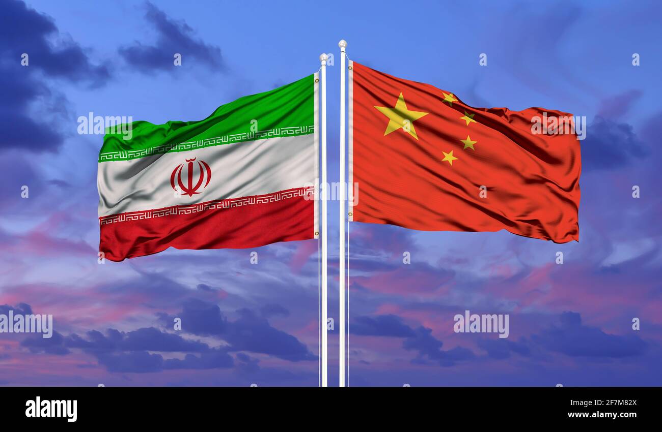 Iran and China flag waving in the wind against white cloudy blue sky together. Diplomacy concept, international relations. Stock Photo