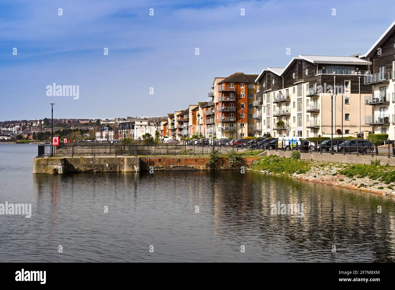 Barry, Wales - March 2021: Flats in apartment buildings on the waterfront in a new housing development around the old docks in Barry Stock Photo