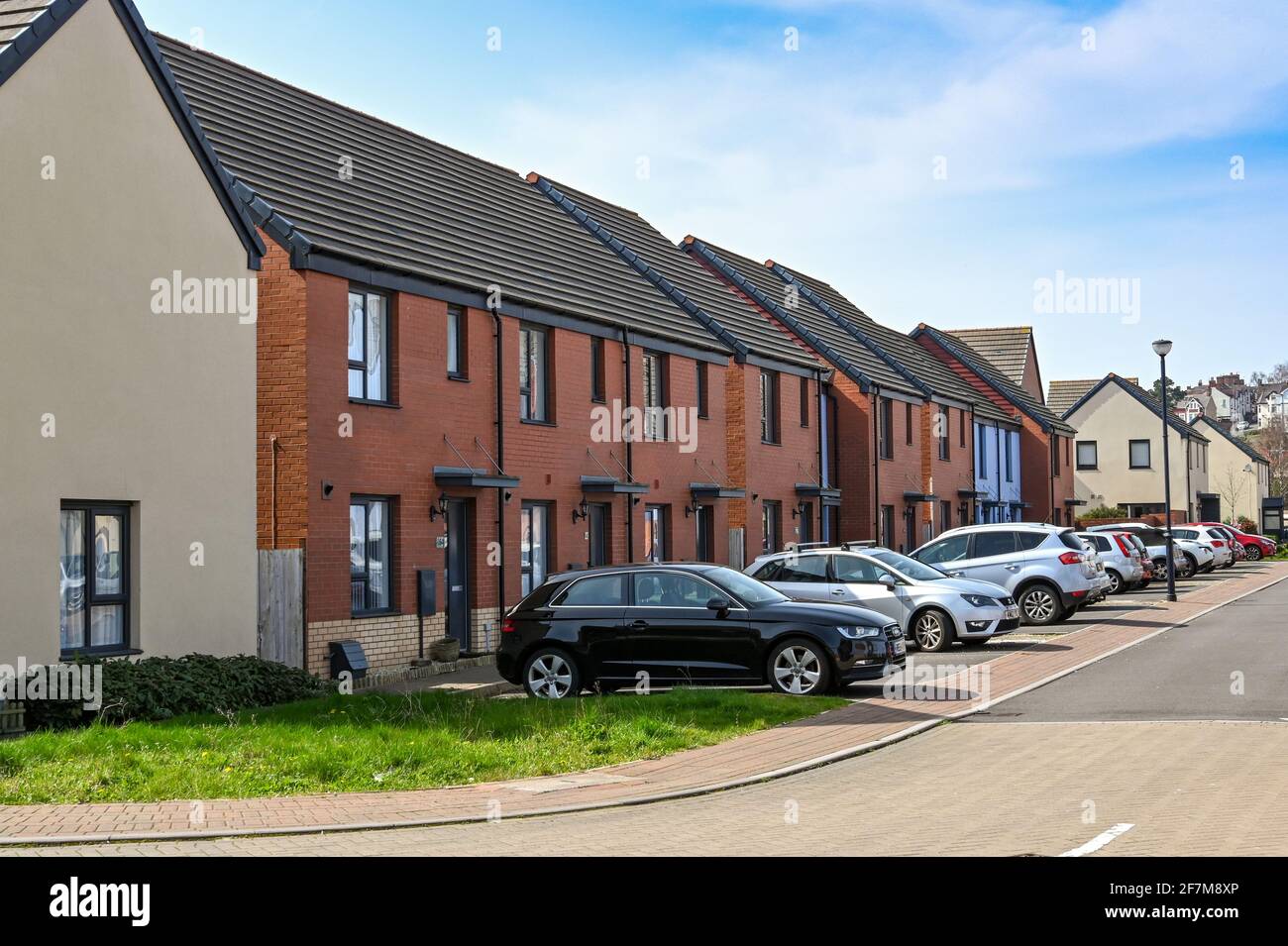 Barry, Wales - March 2021: Link houses with car parking in a new housing development on land around the old docks in Barry Stock Photo