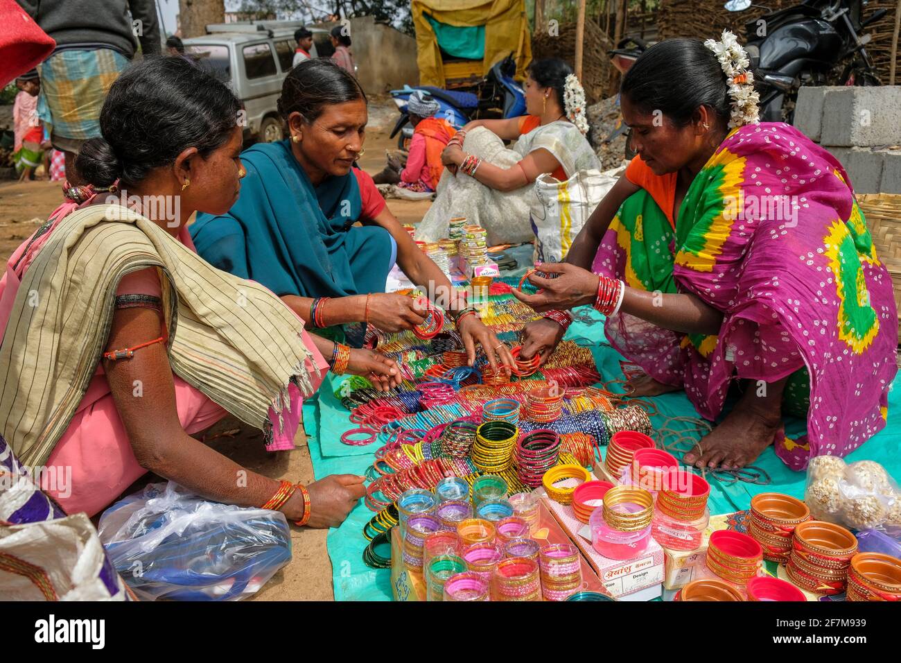 Kunduli, India - February 2021: Adivasi woman from the Kondh tribe buying bracelets in the Kunduli market on February 19, 2021 in Odisha, India. Stock Photo