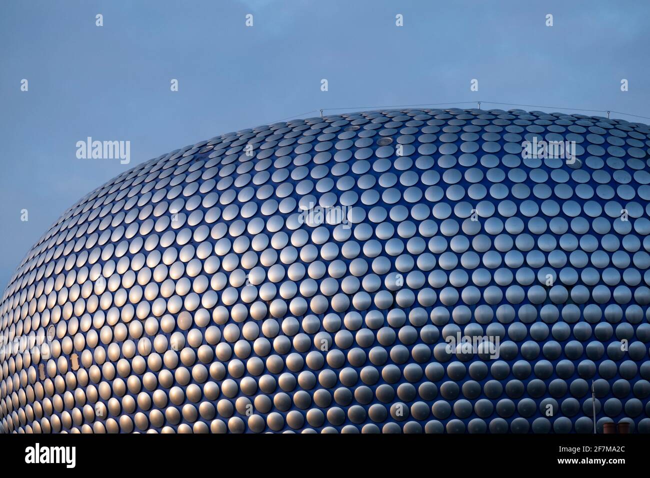 Modern landmark architecture of the Selfridges Building on 7th January 2021 in Birmingham, United Kingdom. The building is part of the Bullring Shopping Centre and houses Selfridges Department Store. The building was completed in 2003 at a cost of £60 million and designed by architecture firm Future Systems. It has a steel framework with sprayed concrete facade. Since its construction, the building has become an iconic architectural landmark and seen as a major contribution to the regeneration of Birmingham. Stock Photo