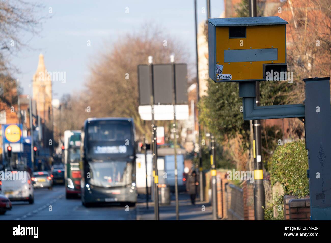 Vehicles approaching a yellow speed camera in Wake Green on 7th January 2021 in Birmingham, United Kingdom. A traffic enforcement camera is a camera which may be mounted beside or over a road or installed in an enforcement vehicle to detect traffic regulation violations, including speeding. Stock Photo