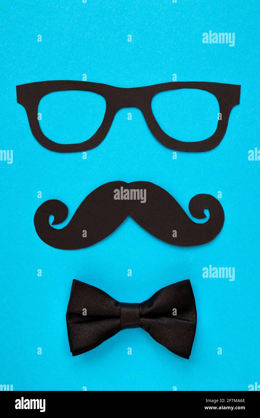 happy father day card, composition with black mustache eyeglasses and bow tie isolated on blue background Stock Photo