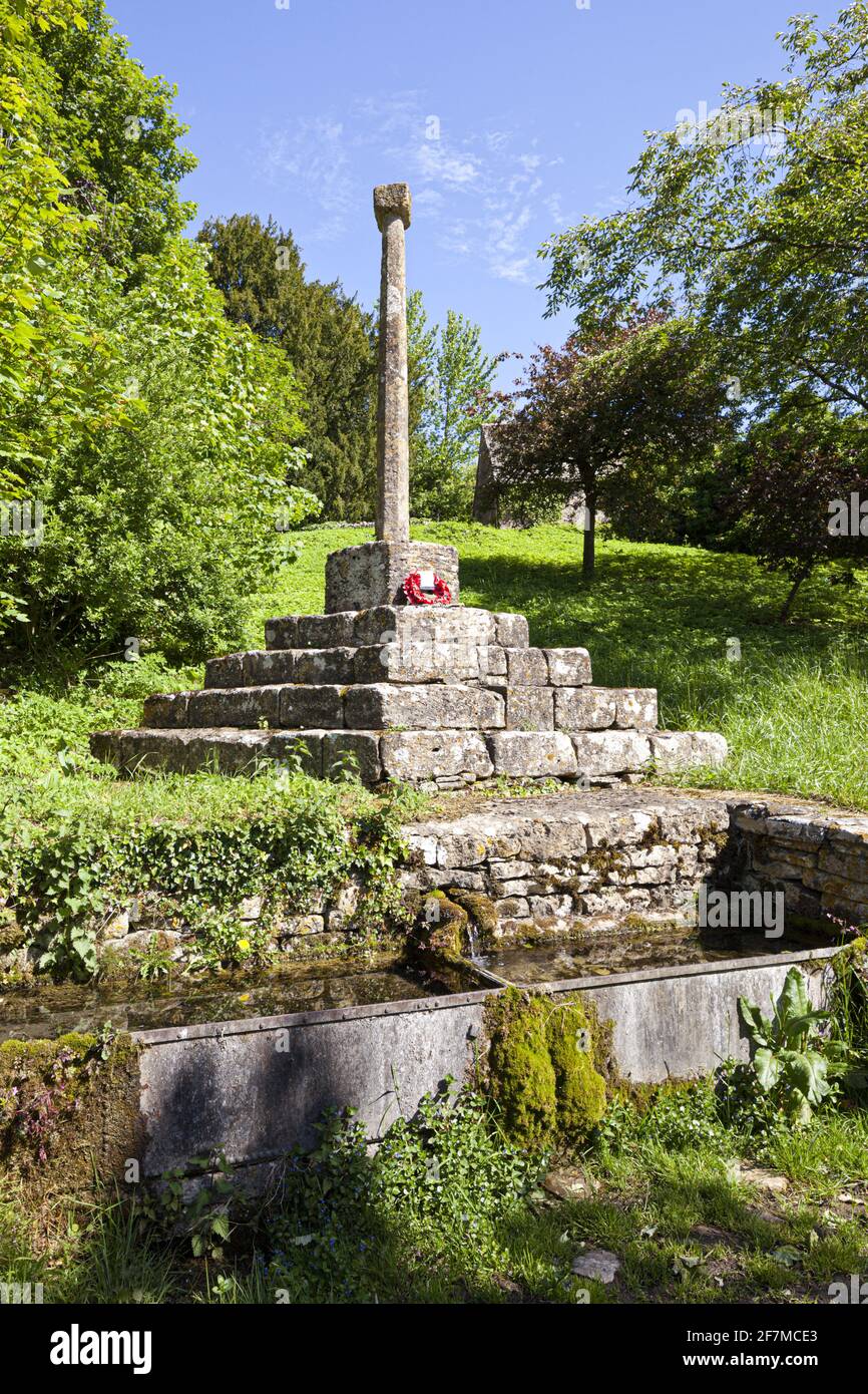 The 14th century wayside cross above the spring in the Cotswold village of Calmsden Gloucestershire UK Stock Photo