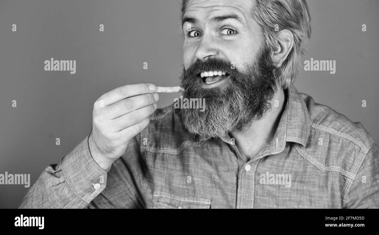 french fries at the street food market. bearded guy having snack. lazy ...