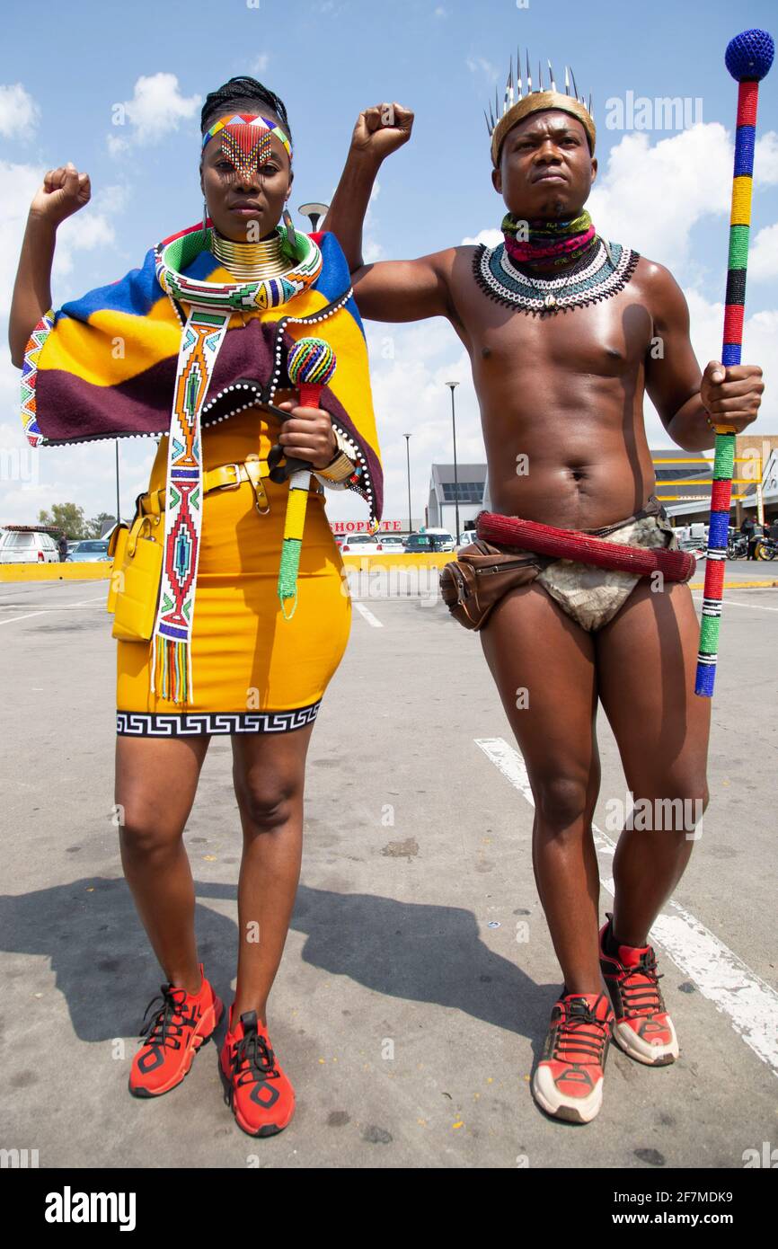 Johannesburg, South Africa. 08th Apr, 2021. Activist Nqobile Maluku (L) and Thando Mahlangu (R) wearing traditional attire raise their fists during a protest outside the Boulders Shopping Centre, after a store manager asked a man to leave for being dressed in the traditional Ndebele attire. (Photo by Thabo Jaiyesimi/SOPA Images/Sipa USA) Credit: Sipa USA/Alamy Live News Stock Photo