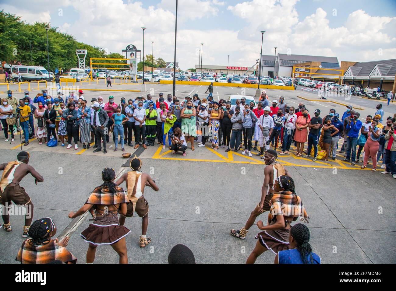 Johannesburg, South Africa. 08th Apr, 2021. People look on as demonstrators dressed in traditional attire dance during a protest outside the Boulders Shopping Centre, after a store manager asked a man to leave for being dressed in the traditional Ndebele attire. (Photo by Thabo Jaiyesimi/SOPA Images/Sipa USA) Credit: Sipa USA/Alamy Live News Stock Photo