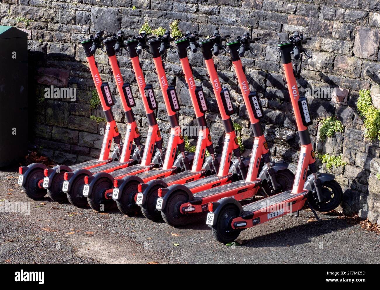 Electric scooters run by Swedish company Voi lined up on a Bristol UK street Stock Photo