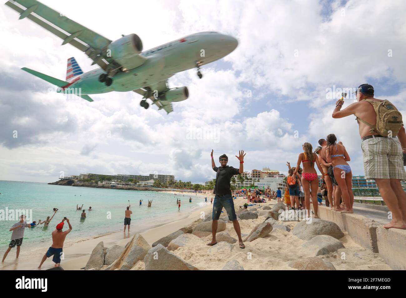 plane takes off on the background behind a young man. young male is